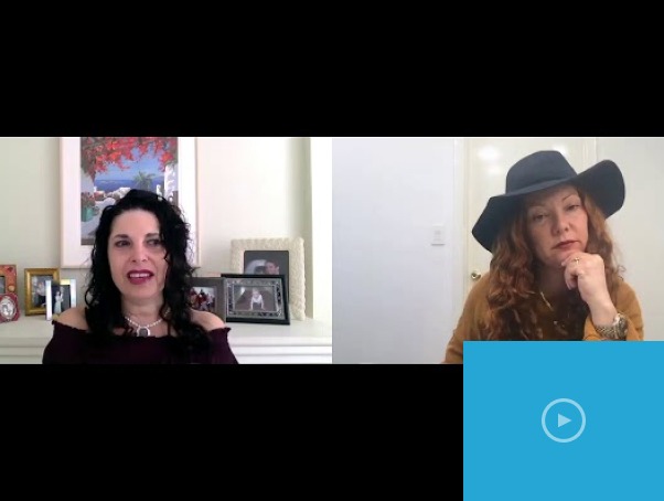 A virtual meeting screenshot shows two women. The one on the left, with dark curly hair, speaks animatedly in front of a fireplace adorned with framed photos—a fitting backdrop for an SEL activities session. On the right, a red-haired woman in a wide-brimmed hat appears thoughtful.