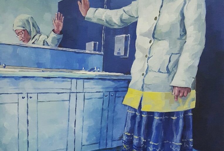 A woman in a white headscarf and long skirt stands in a blue-toned bathroom. She looks at a red book on the floor, extending one hand toward a mirror that reflects her. This scene subtly mirrors themes often explored in diversity programs, embracing self-awareness and reflection.