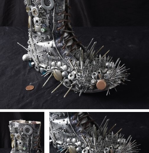 A boot decorated with metal spikes, bolts, and buttons on a black surface exudes rugged charm. Silver and bronze objects add to its industrial appeal, with a penny nearby for scale. This design shares the creativity found in SEL activities, sparking curiosity much like get-to-know-you activities for students.