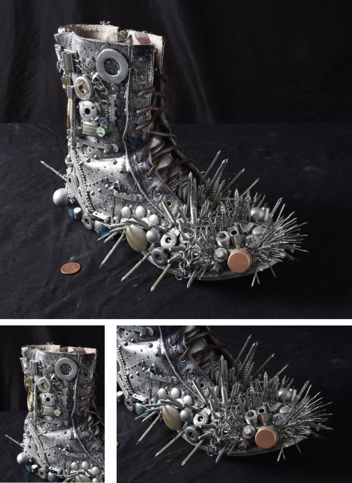 A boot decorated with metal spikes, bolts, and buttons on a black surface exudes rugged charm. Silver and bronze objects add to its industrial appeal, with a penny nearby for scale. This design shares the creativity found in SEL activities, sparking curiosity much like get-to-know-you activities for students.